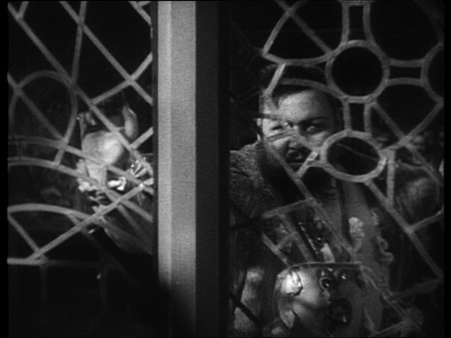 Figure 3. Henry VIII (Charles Laughton) peering through a lattice window in The Private Life of Henry VIII (Alexander Korda, 1933).