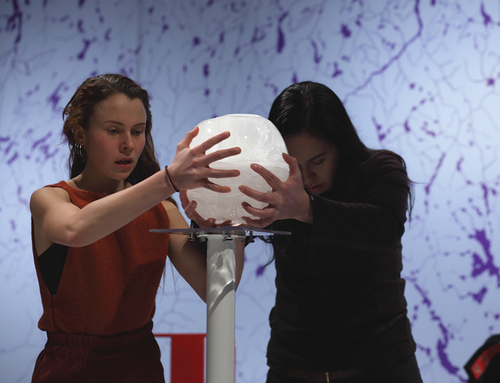 Image 3. Sarakka Gaup and Elina Israelsson hold the white crystal sphere filled with water which was the central prop of the production of CO2lonialNATION. Photograph by Ilkka Volanen. © Giron Sámi Teáhter.