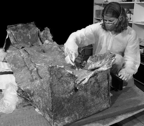 Figure 7. The lead coffin-lining in the final stages of cleaning and conservation prior to the removal of its cover and the excavation of the skeleton within.