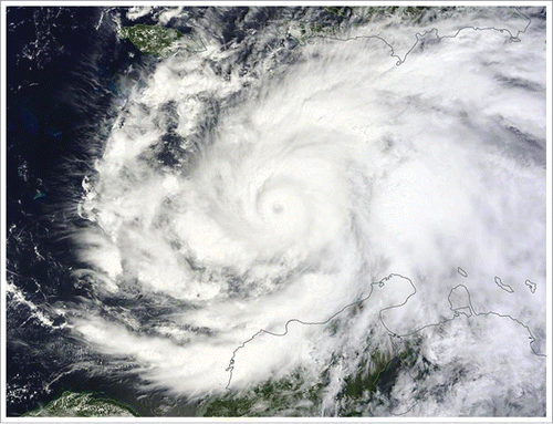 Figure 1. NASA satellite image of Hurricane Matthew at Category 4 strength near the north coast of South America and south of Haiti on Oct 2, 2016. Photo by NASA. Source: https://worldview.earthdata.nasa.gov/?p=geographic&l=VIIRS_SNPP_CorrectedReflectance_TrueColor(hidden),MODIS_Aqua_CorrectedReflectance_TrueColor(hidden),MODIS_Terra_CorrectedReflectance_TrueColor,Reference_Labels(hidden),Reference_Features(hidden),Coastlines&t=2016-10-02&z=3&v=-97.34765625,1.44140625,-52.34765625,23.58984375