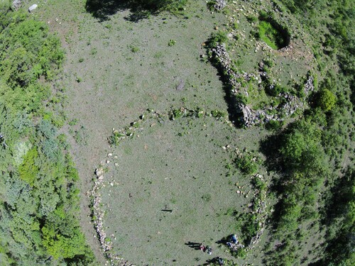 Figure 2. Aerial photograph showing a pit structure and a circular stone enclosure at Nyahokwe Site.