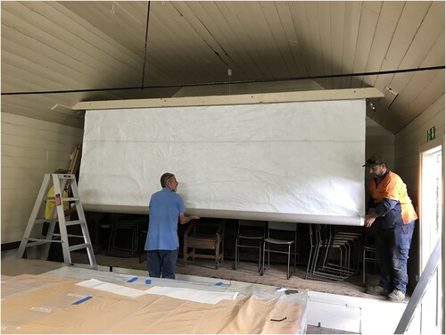 Figure 5. Peter van Diesen, Phil Large and Kevin Fleischer unrolling the curtain protected by its veil. Note the upper rings pivoted to the sides to allow unrolling, image S Cotte.