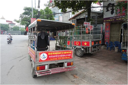 Figure 1. Three-wheeler vehicles waiting for an assignment at one of Hanoi’s busy intersections. Drivers decorate their vehicles to emphasise their disabled veteran status. Source: author.