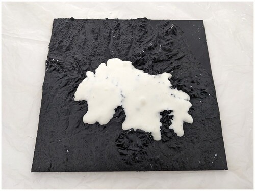 Photo 1. Flubber placed on a 3D-printed model of a mountain landscape flows downhill, analogous to how glaciers flow.