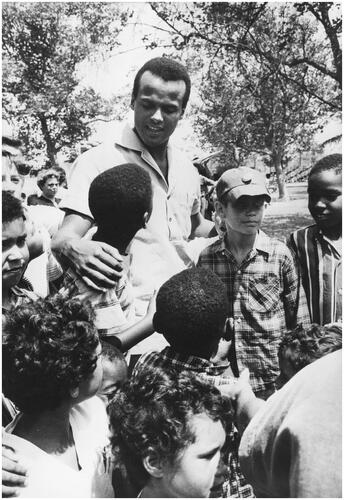 Figure 2 Unknown photographer, ‘Belafonte being greeted by a group of admiring youngsters upon his arrival at the Friendship Day Camp near Los Angeles, California’. ‘Vocal Lesson by Belafonte’, 1957. USIA ‘Picture Story’ Photographs, 1955–84, Record Group 306. 306-ST-435-57-24373.