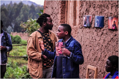 Figure 4. Richard Aime Ingabire talks at his Home Stay Exhibition 2022, with Jacques Nkinzingabo in the background © Kigali Centre of Photography.